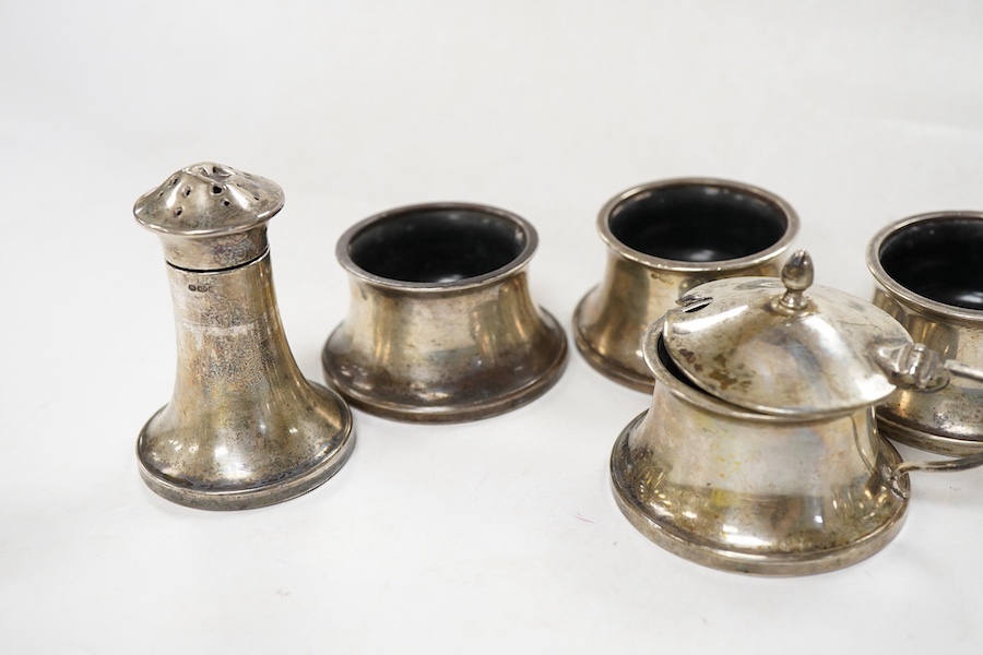 A George V seven piece silver mounted condiment set, by Joseph Gloster Ltd, Birmingham, 1932, pepper 65mm (a.f.).